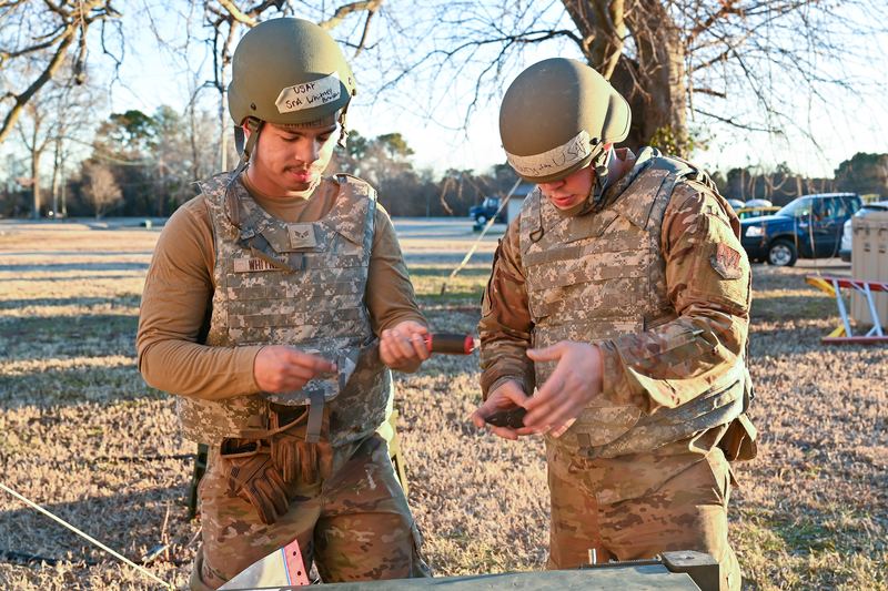 U.S. Air Force Senior Airman Brayden Whitney, left, and Staff Sgt. Eric Young, 633d Civil Engineer Squadron heating, ventilation, and air conditioning technicians, prepare their to